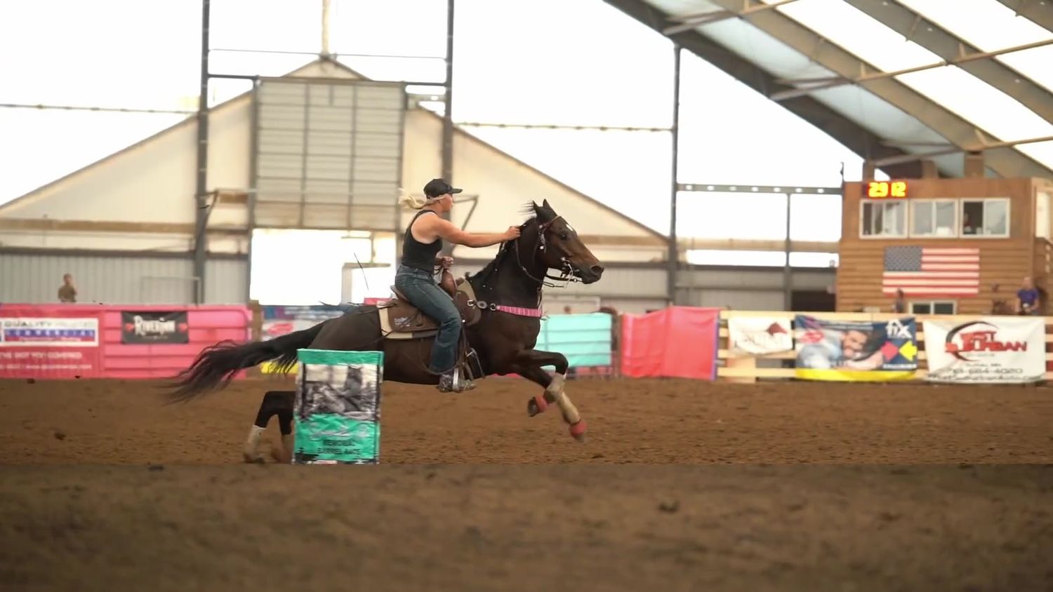 Grey horse rounding a barrel